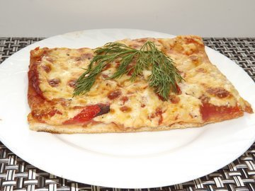 Pizza with tomatoes on Italian pizza dough