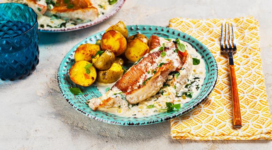 Sea bass in a pan in a creamy sauce with basil