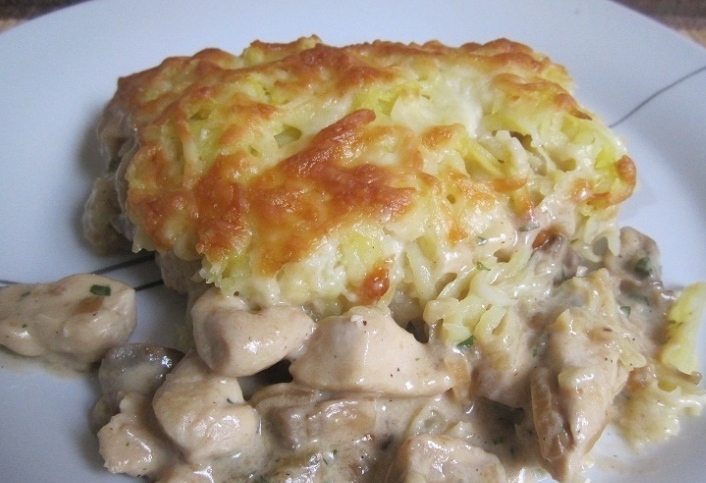 Chicken with mushrooms baked under a potato coat