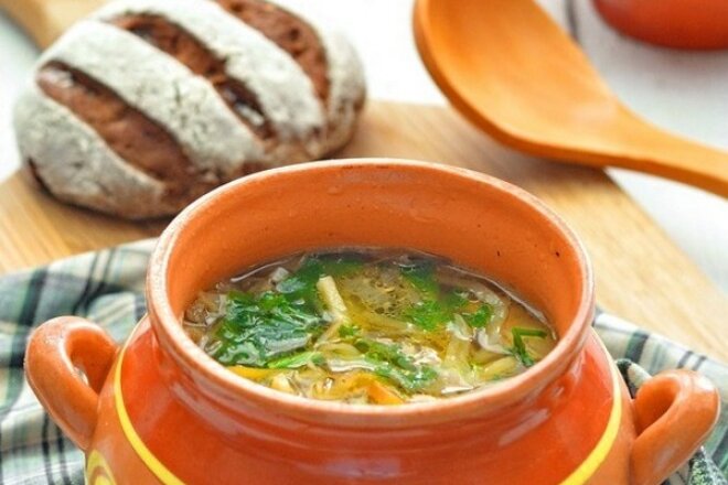 Cabbage soup with bell pepper in a pot