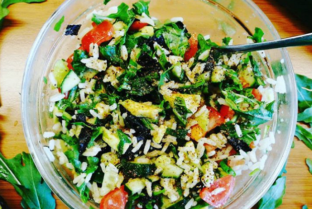 Asian salad with rice, cucumber and tomato