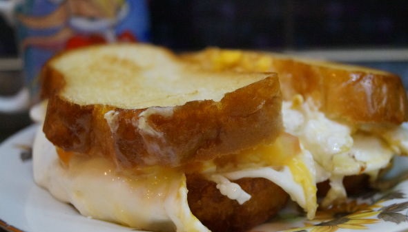 Scrambled eggs in bread, with cheese and tomato