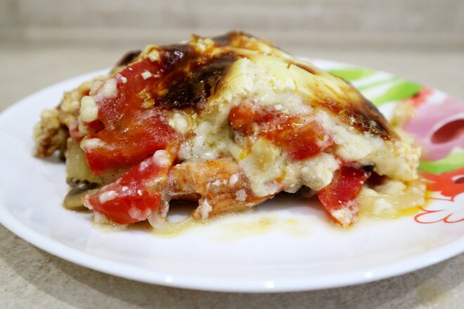 Pork With Mushrooms, Tomatoes, Onions And Cheese In The Oven