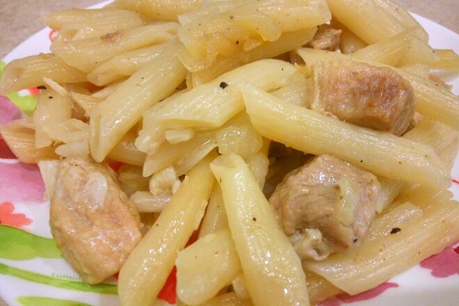 Stewed Meat With Pasta And Onions In A Pan