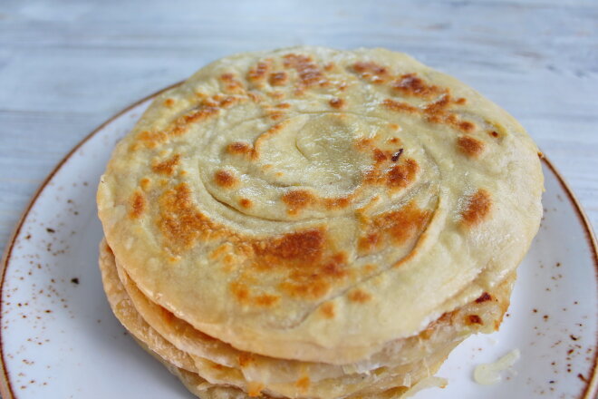 Uzbek Puff Pastry Katlama With Onions In A Pan